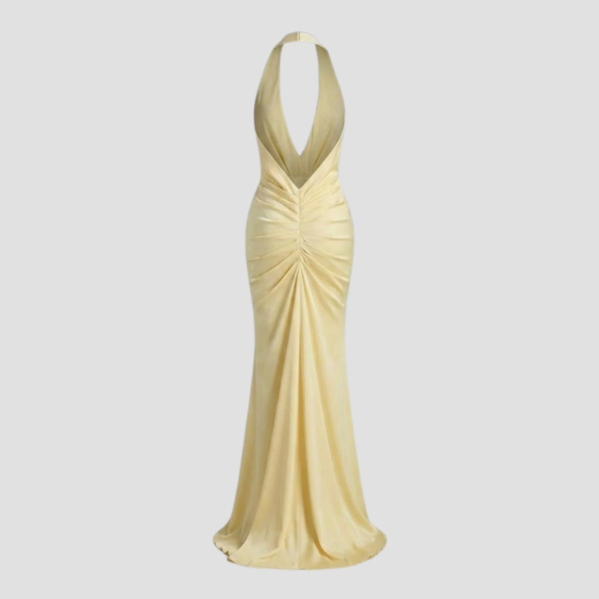 Flat lay of the back of the Kouvr Beverly backless maxi dress in Light yellow, showing the adjustable halter ties and ruched back construction.