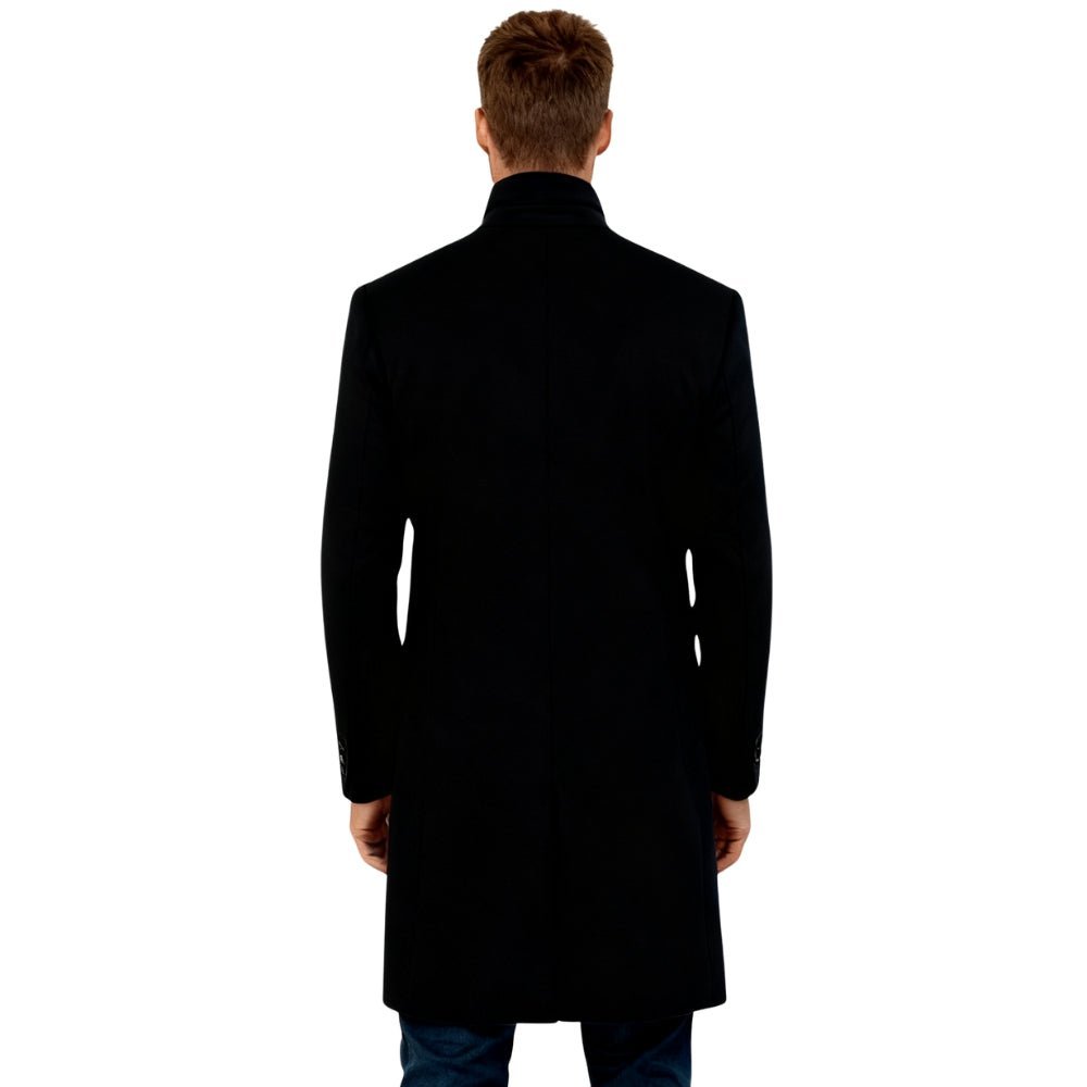 Man wearing a black Kouvr overcoat on a white background