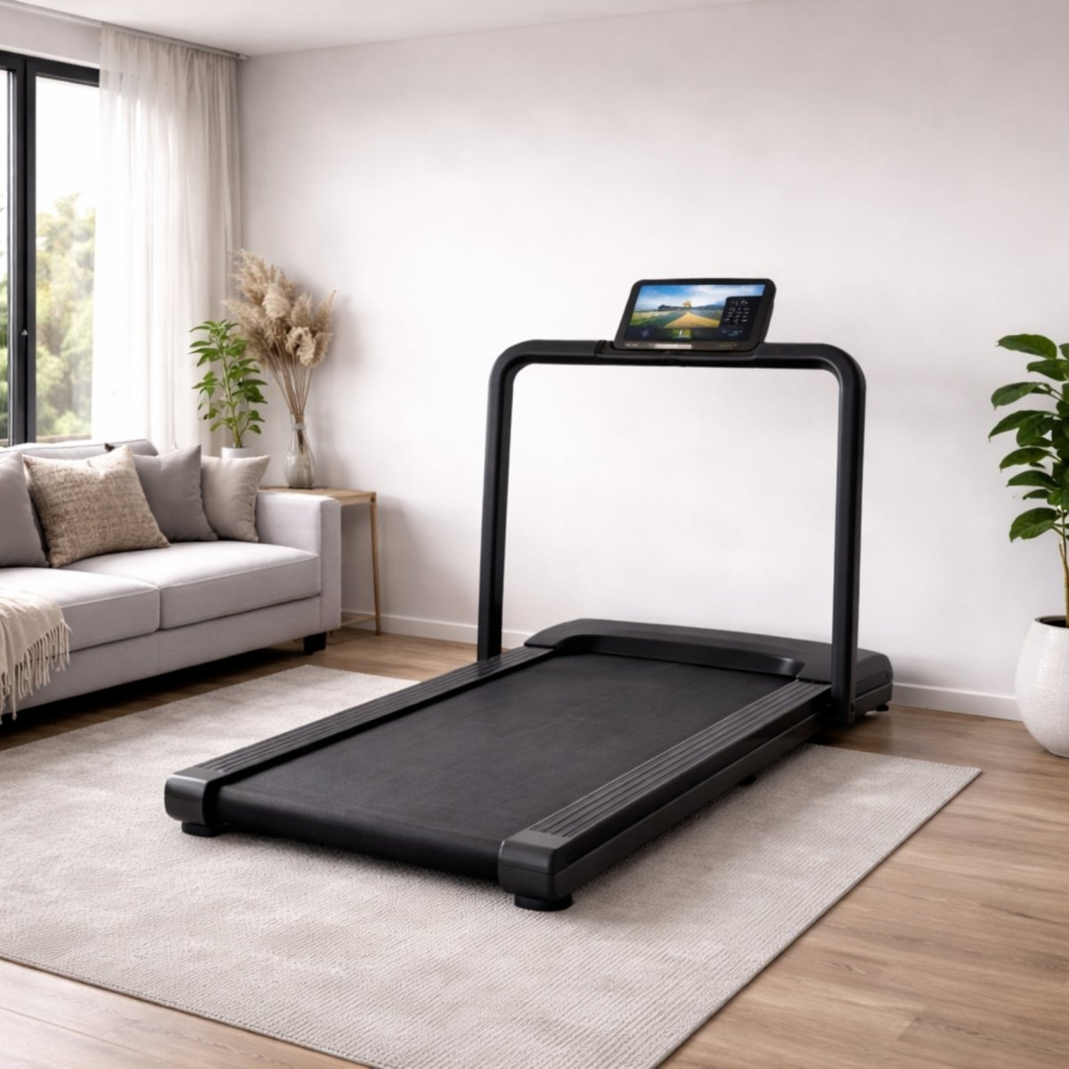 Sleek black Kouvr folding treadmill unfolded and ready for use in a minimalist living room