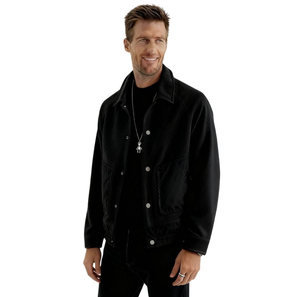 Man wearing a black kouvr jacket on a white background