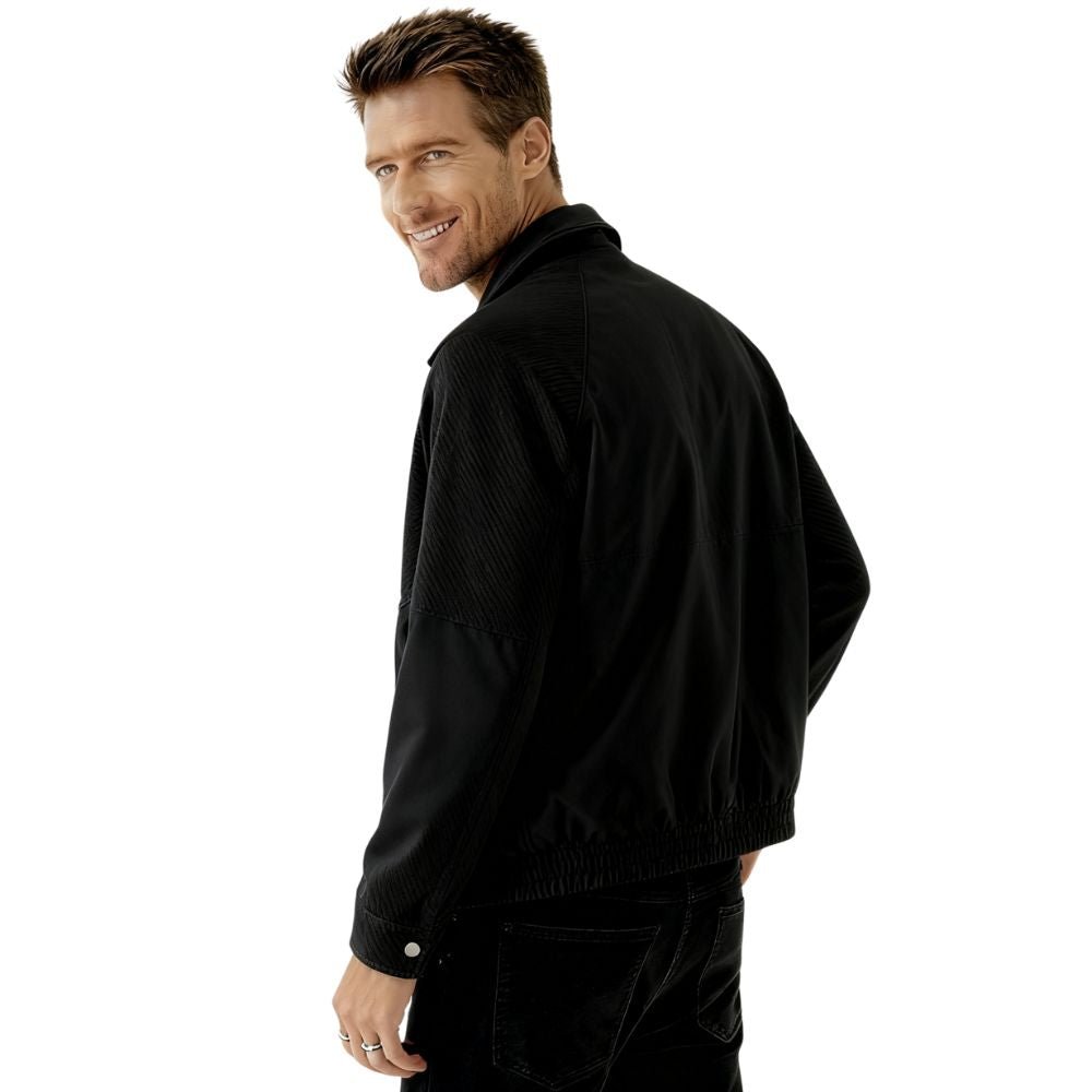 Model wearing the Kouvr men's black textured corduroy and nylon trucker jacket