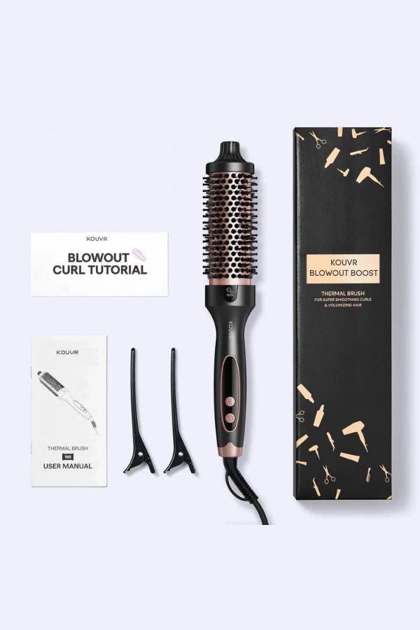 Complete Kouvr Blowout Boost set including black thermal brush, luxury gift box, sectioning clips, and user manual flat lay.