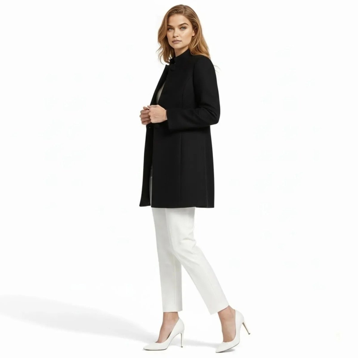 Side profile of a woman wearing the black Brandi high collar coat, highlighting its tailored fit and clean lines against a white background.