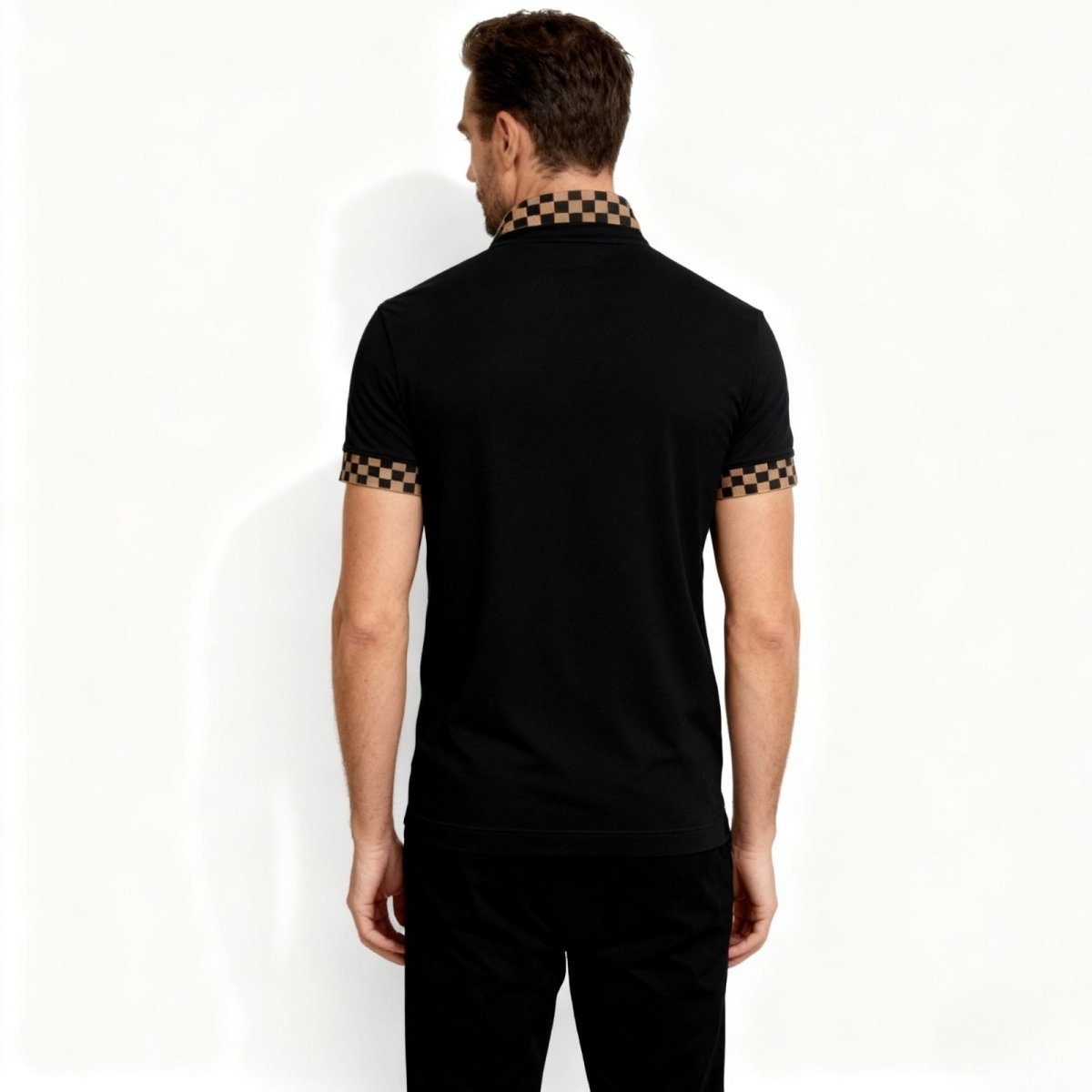 Back view of the Kouvr men's black polo shirt, showing the clean design and the distinct checkerboard collar from behind.