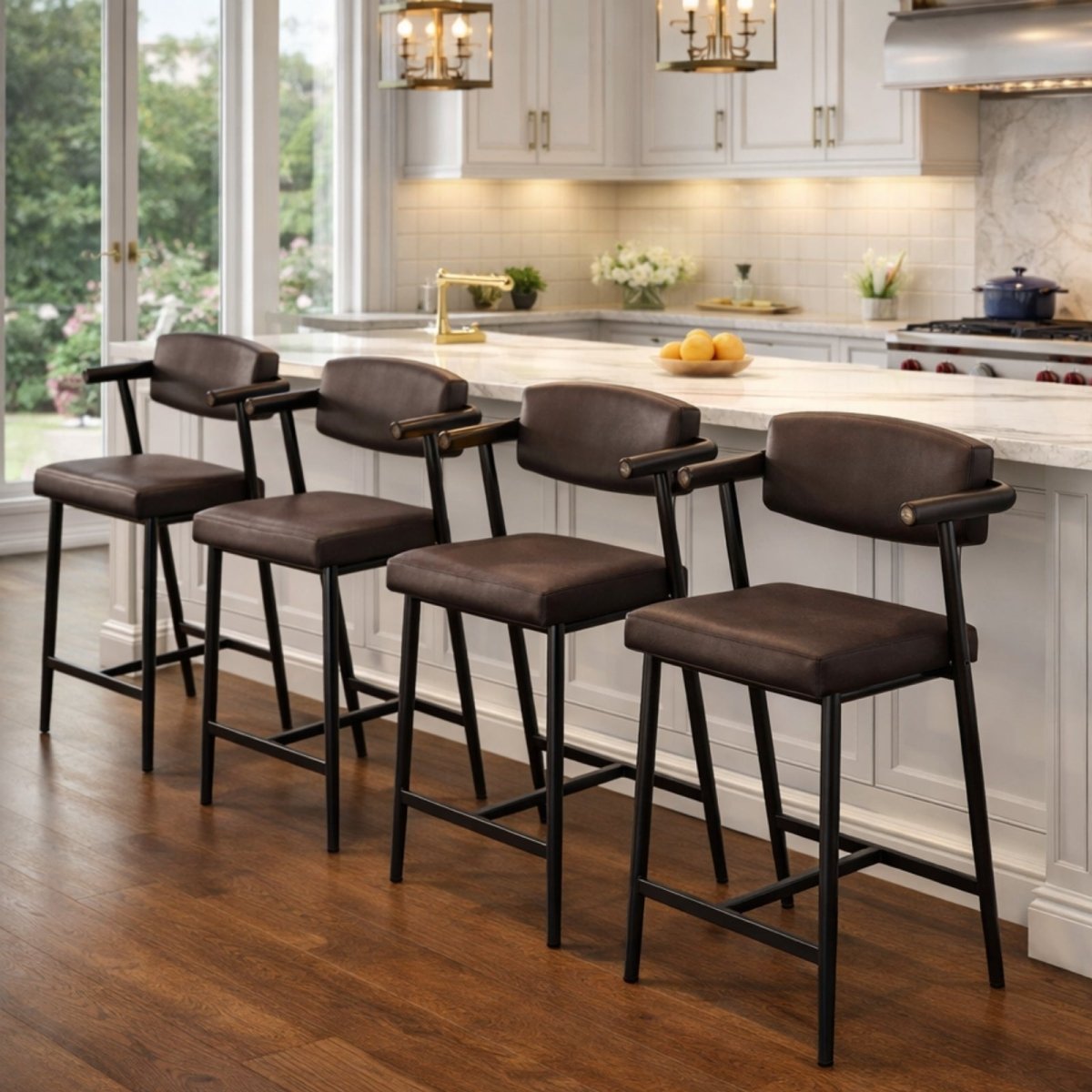 A set of four Kouvr brown faux leather counter height stools with black metal frames lined up at a white marble kitchen island.