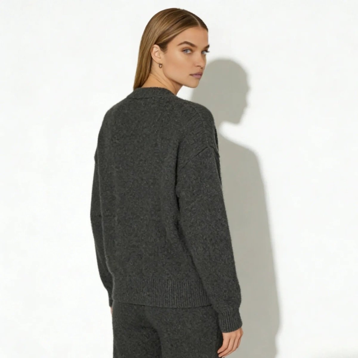 Back view of the Kouvr Fashion dark gray cardigan on a model, highlighting the diamond-knit texture.