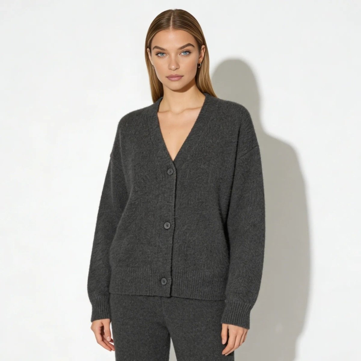Model facing forward wearing the Kouvr Fashion dark gray cashmere blend V-neck cardigan.