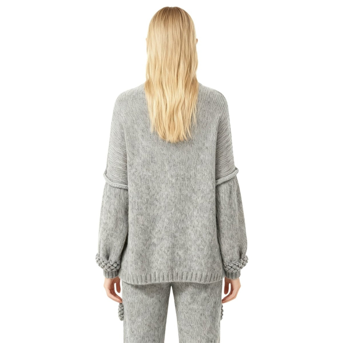 Person wearing a gray Kouvr knit outfit on a white background