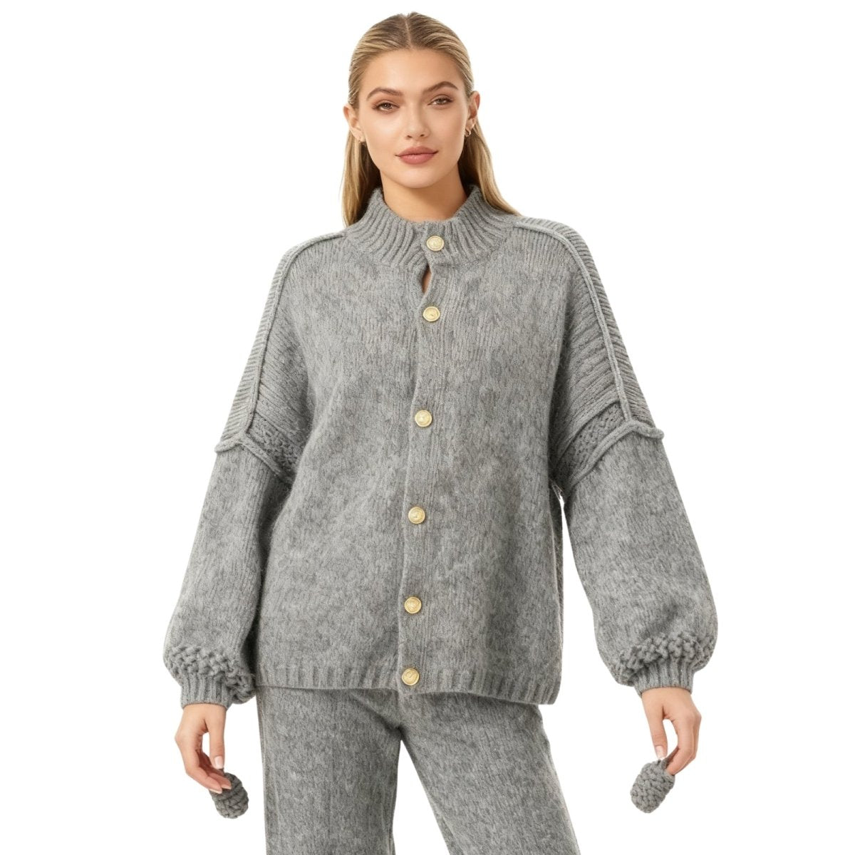 Woman wearing a gray Kouvr knitted cardigan with buttons on a white background