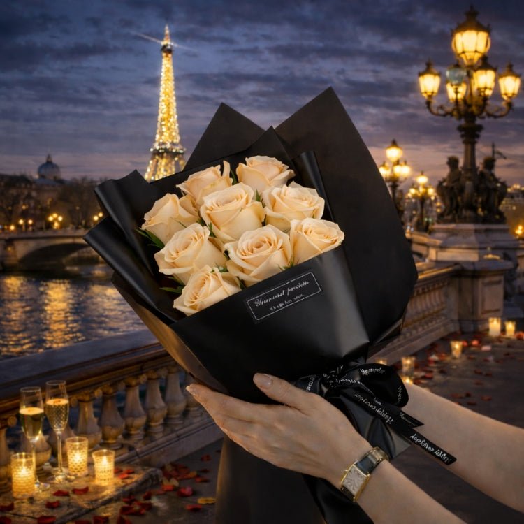 A bouquet of 9 champagne-colored everlasting roses from Kouvr, held against a romantic Paris backdrop, perfect for an anniversary gift.