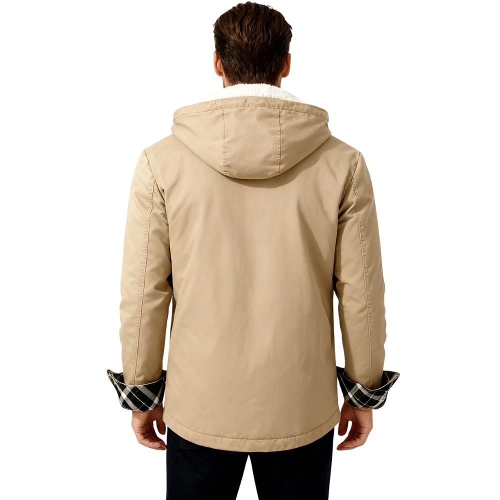 Man wearing a khaki kouvr jacket with plaid cuffs on a white background