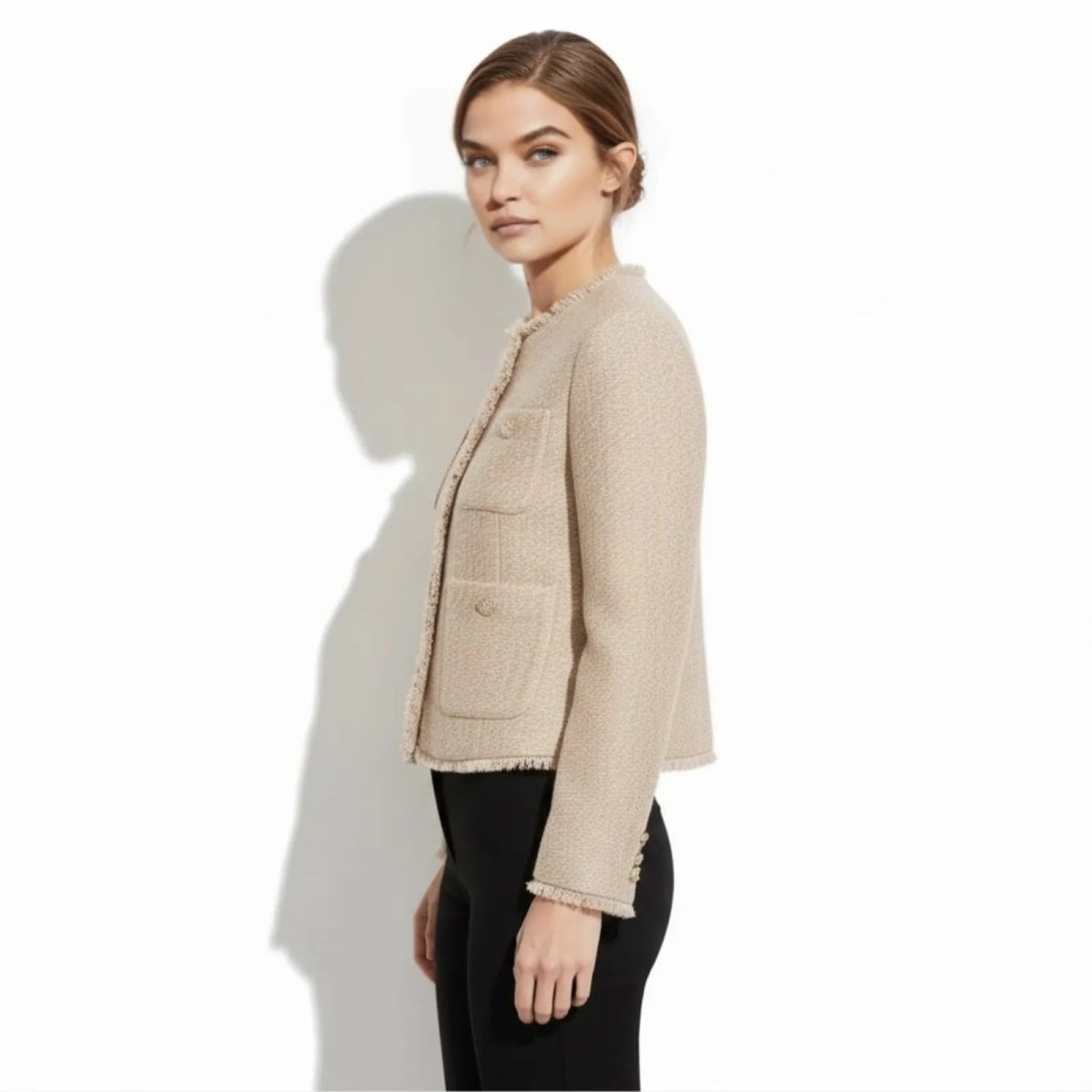 Side profile of a model in the Kouvr beige tweed jacket, showing the tailored fit, sleeve length, and pocket placement.