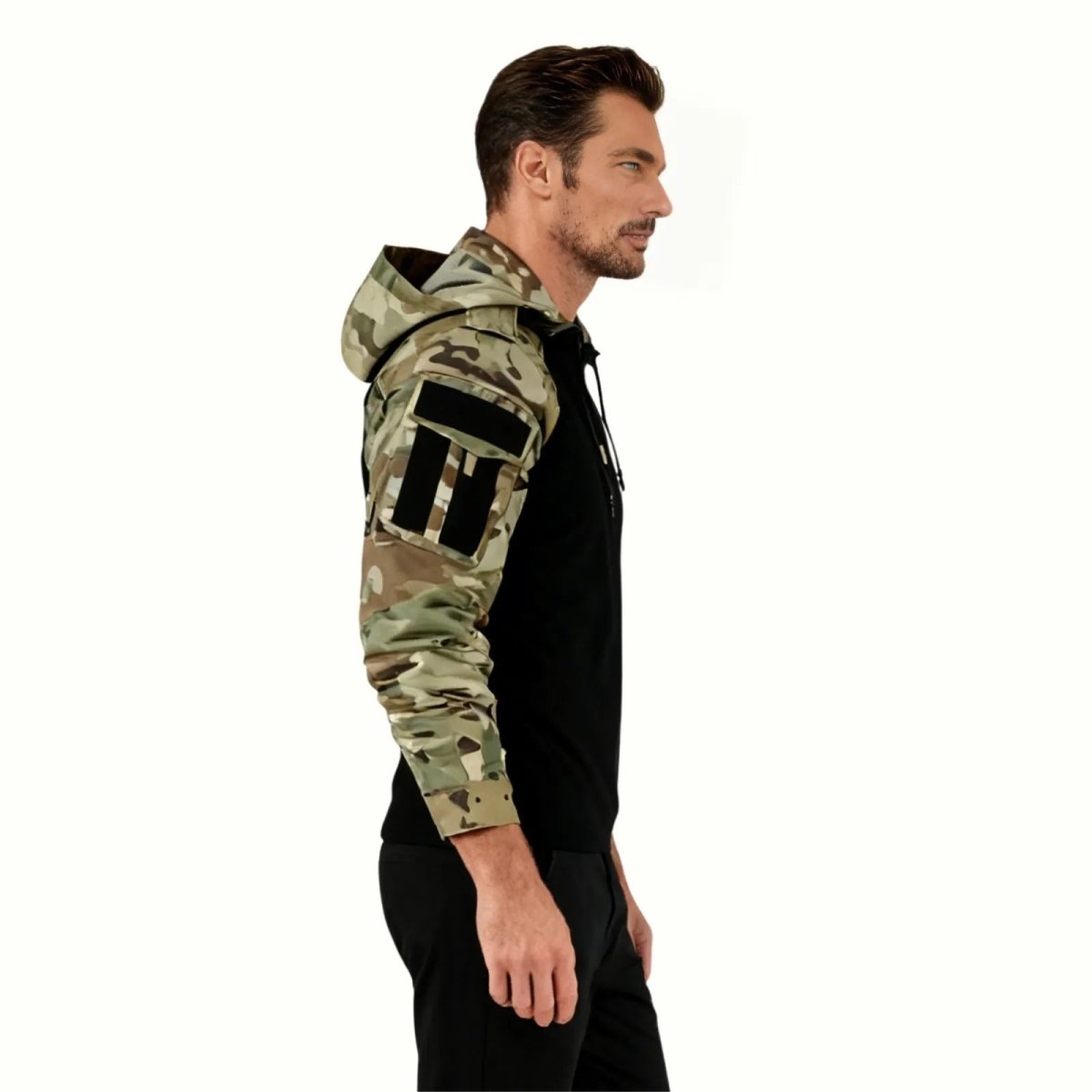 Close-up on the multicam camouflage shoulder of the Kouvr Clint hoodie, showing the loop velcro patch panel and pocket construction.