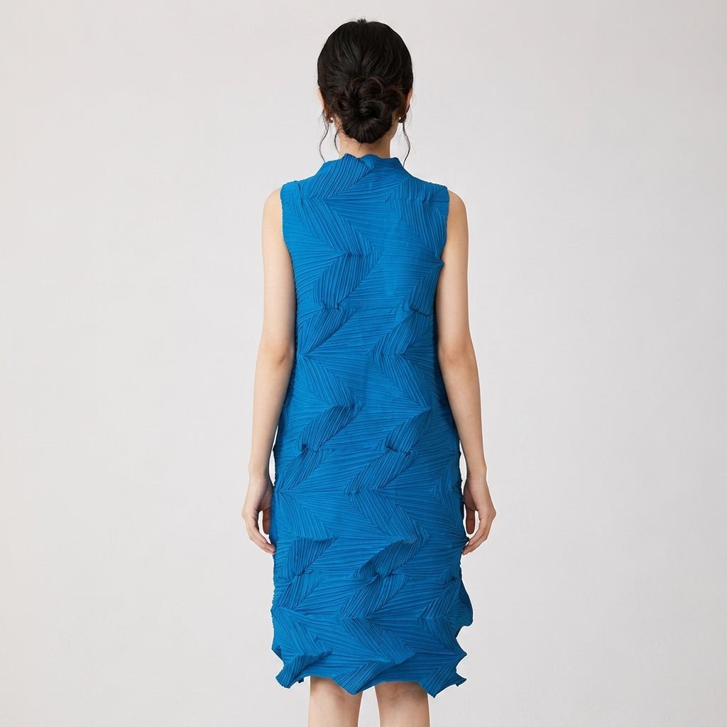Back view of female model showcasing the hidden zipper and geometric texture of the Kouvr blue pleated mock neck midi dress.