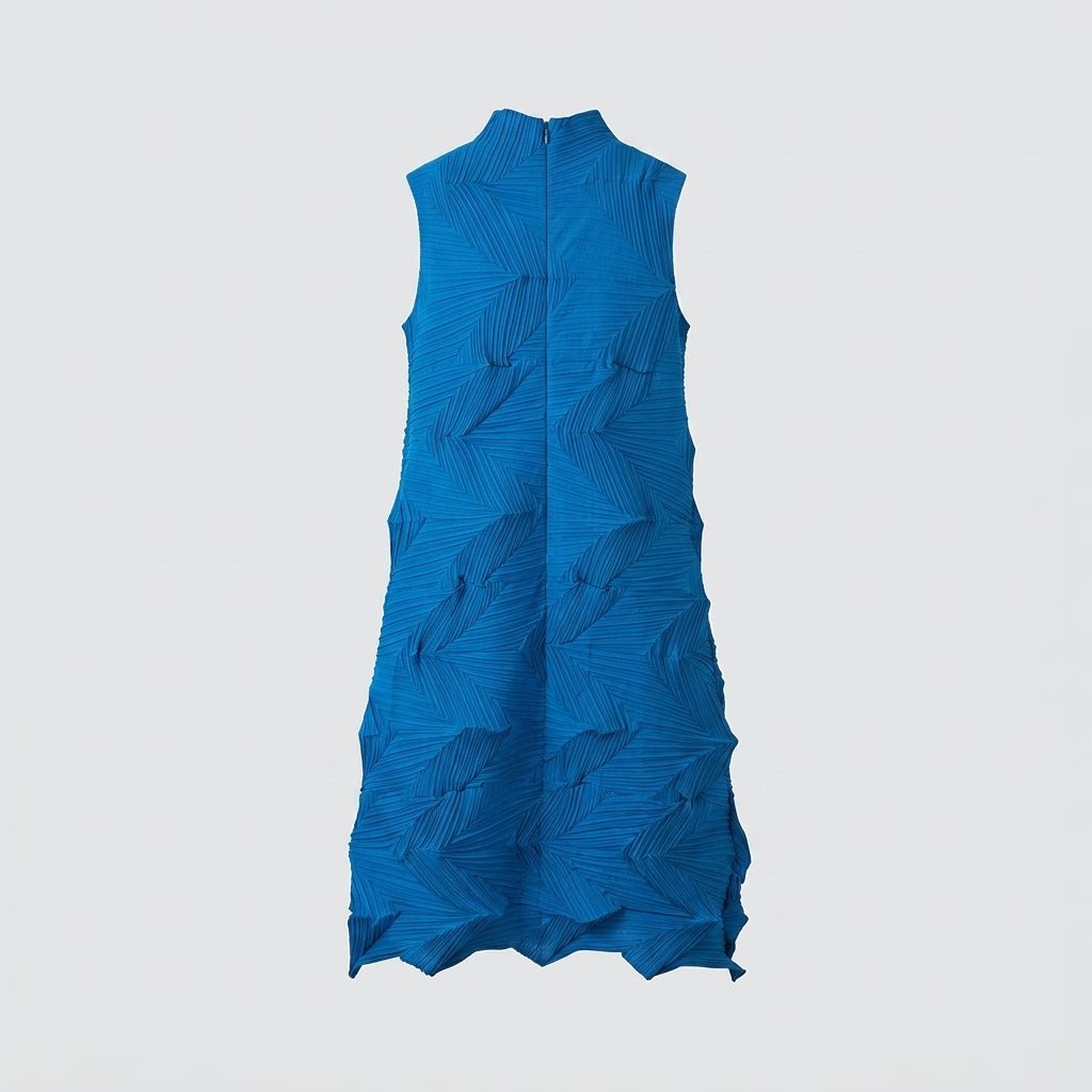 Studio flatlay of the front of the Kouvr cobalt blue 3D geometric pleated mock neck midi dress.