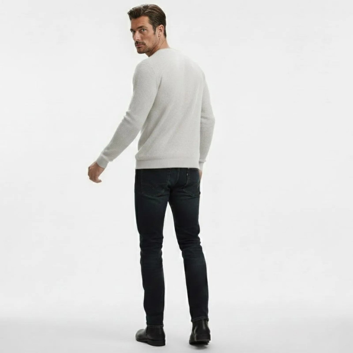 Man from behind wearing Kouvr's chalk white merino blend sweater, showcasing the fit across the back and shoulders.