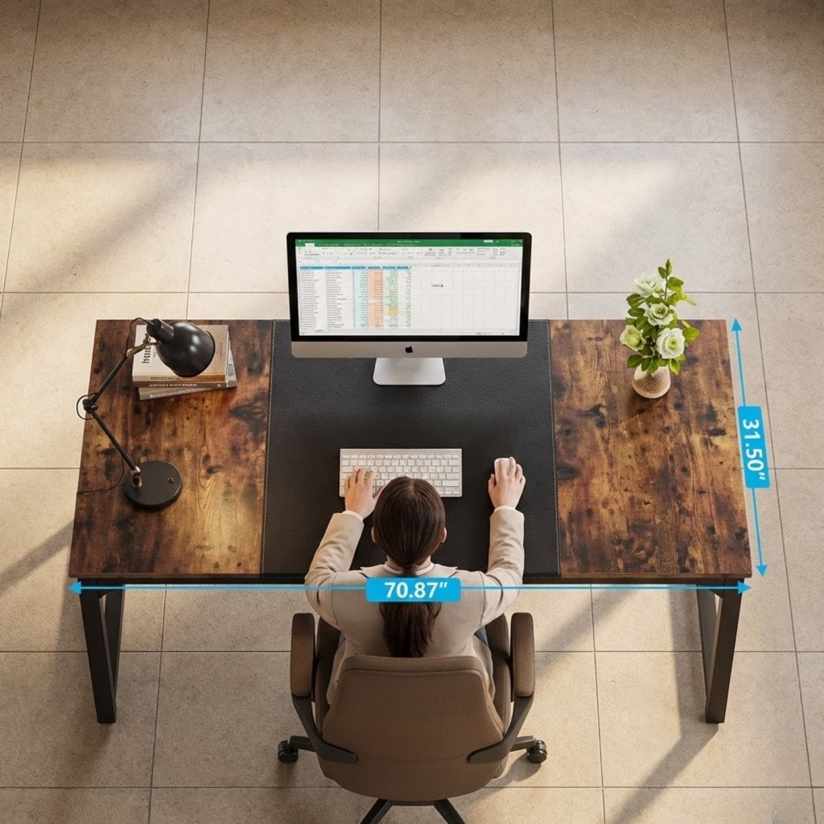 Top-down view of a person working at the spacious Kouvr computer desk, which features a rustic wood grain and a large black center mat.