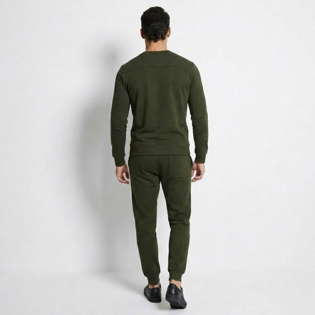 Back view of a man wearing the Kouvr Crue Lounge Set, highlighting the yoke detail on the sweatshirt and fit of the joggers.