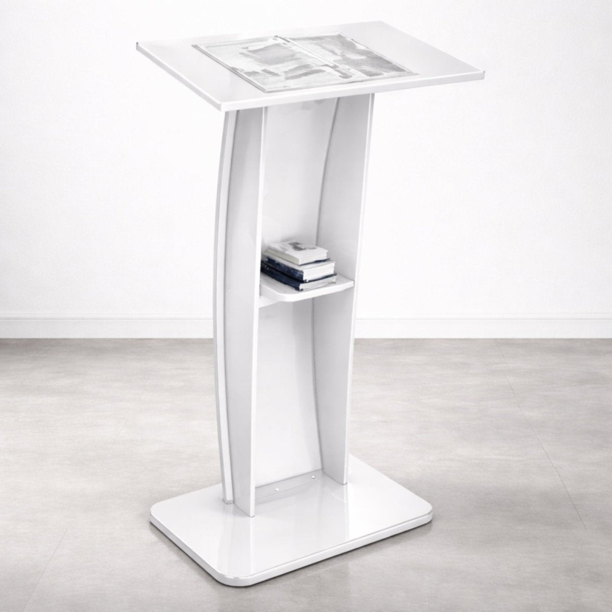 A modern curved acrylic podium in a gloss white finish with an integrated storage shelf, from Kouvr's collection.