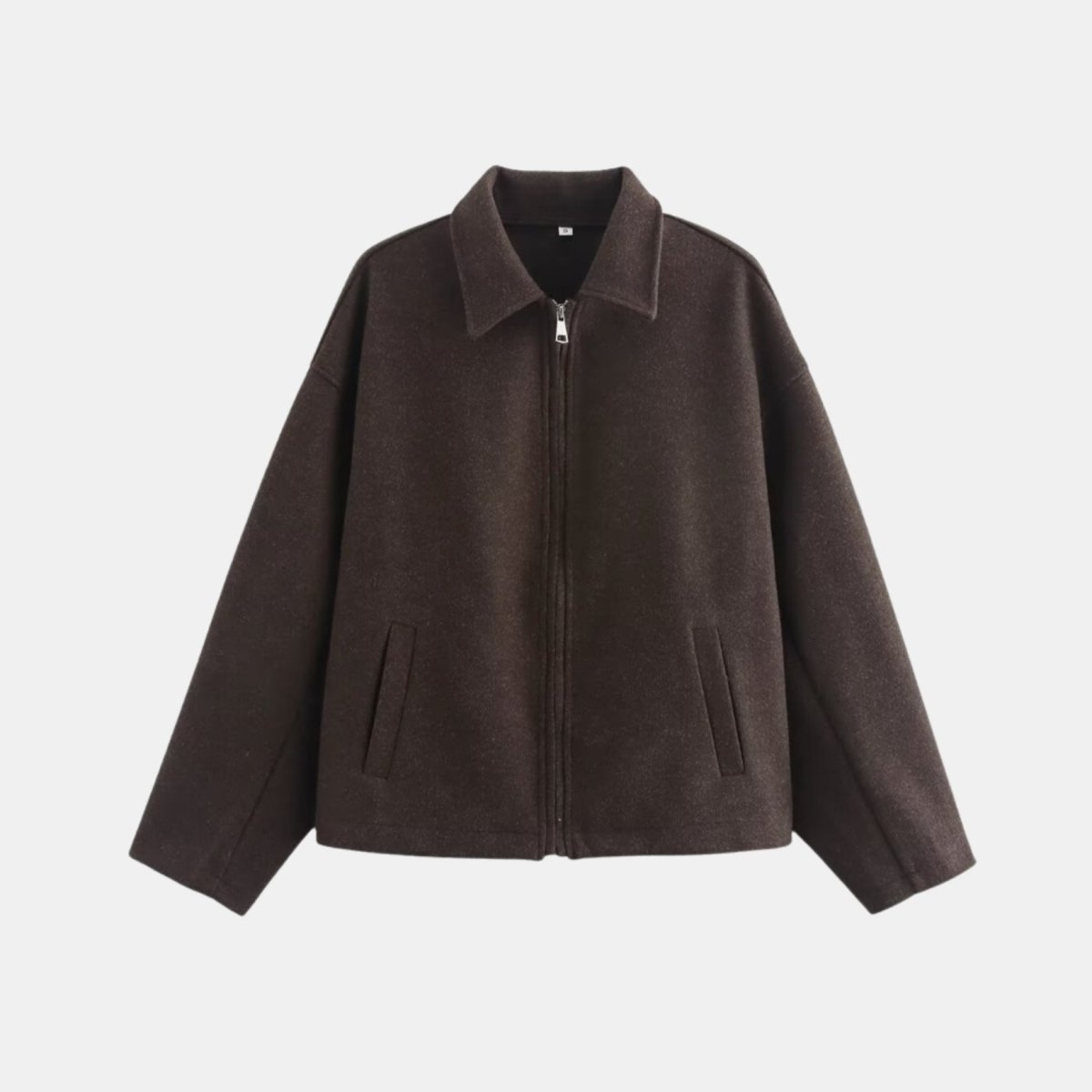 Flat lay studio shot of front zipper and collar details on Kouvr dark brown jacket.