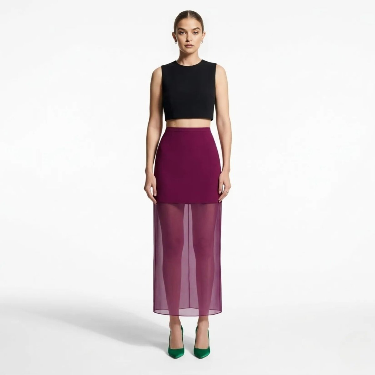 Full length view of Kouvr dark purple mesh panel evening skirt styled with black crop top and green silk heels.