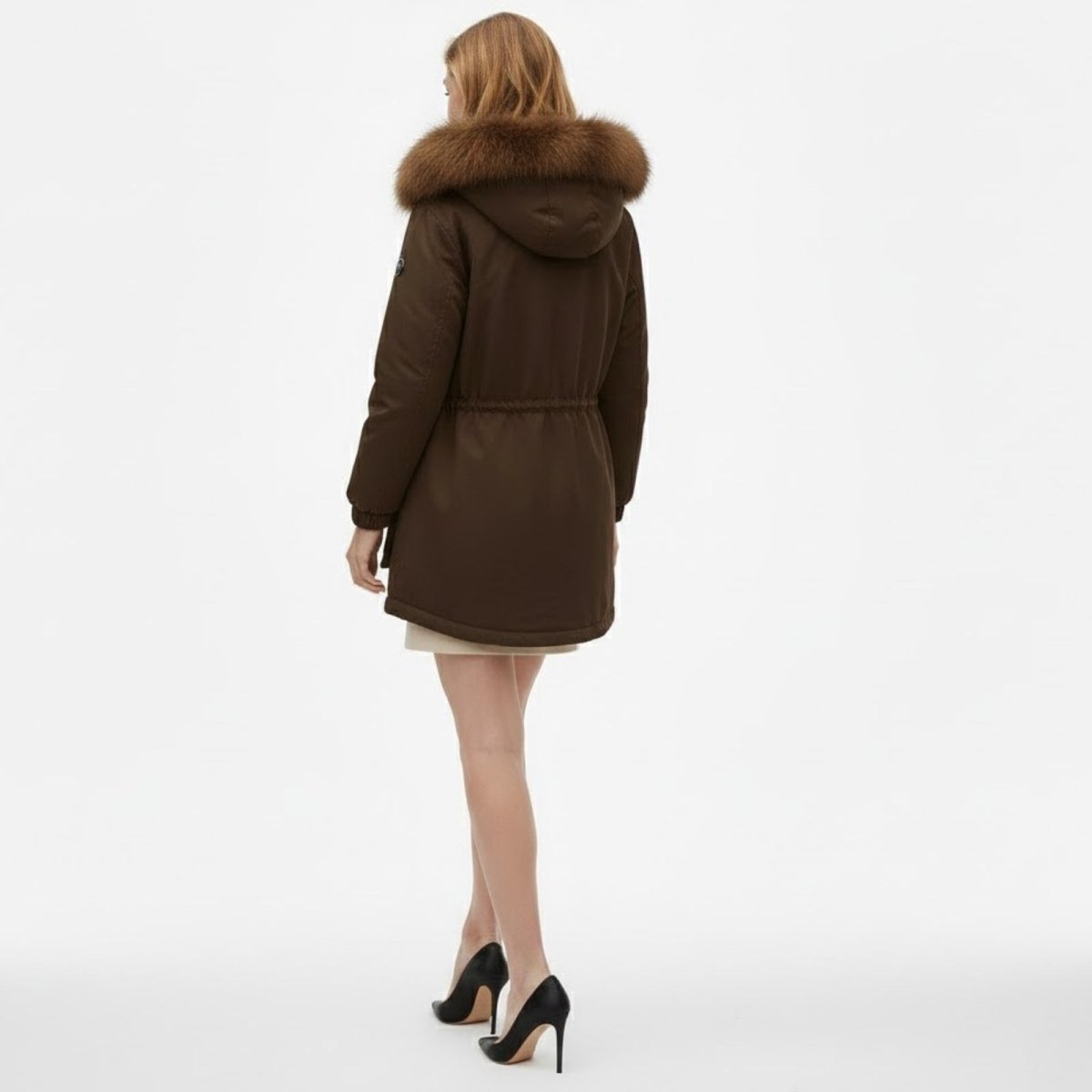 Back view of a model wearing the Kouvr Debra brown parka, highlighting the faux fur hood and cinched waist detail.