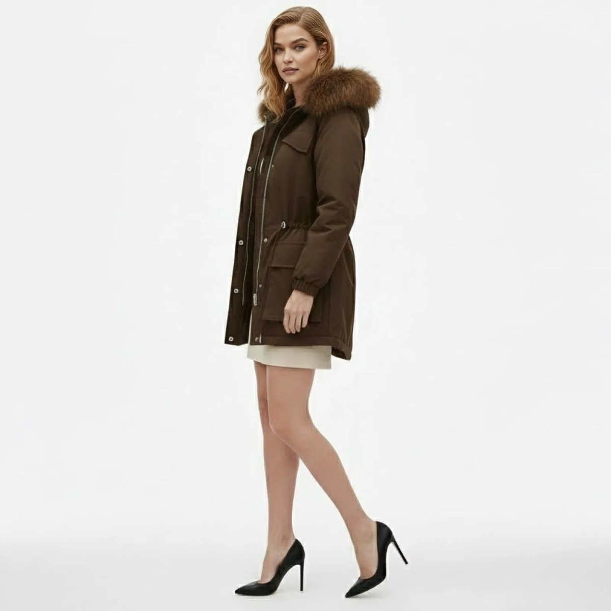 Side profile of a model in the Kouvr Debra brown parka, showcasing the coat's length and fit.