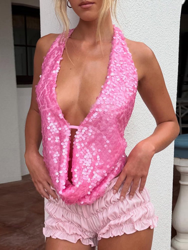 Close-up of a woman in a hot pink Kouvr Della sequin cowl neck top, paired with pink satin shorts for a going out look.