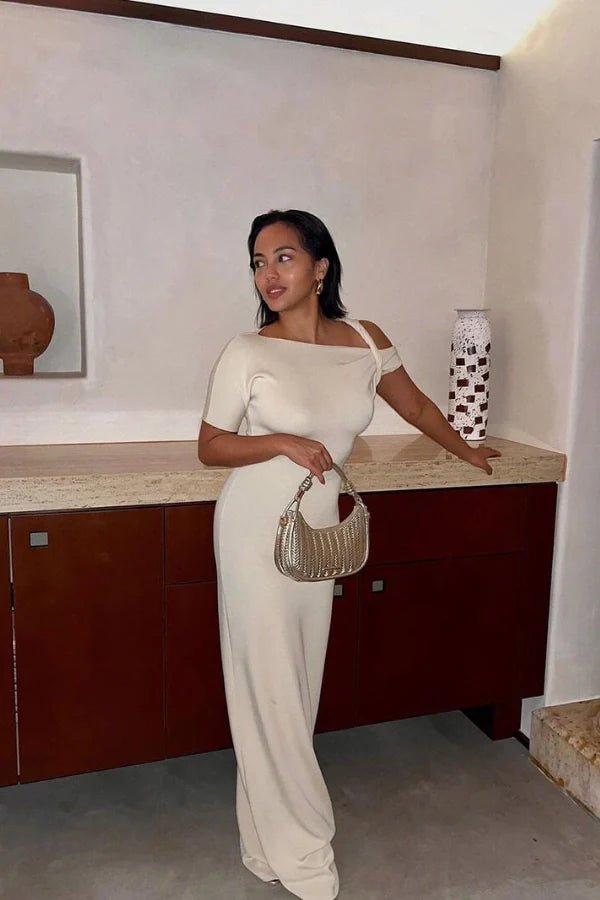 Naturally include related terms like `sculptural silhouette`, `figure-hugging`, `single sleeve gown`, `elegant formalwear`, and `resort evening dress