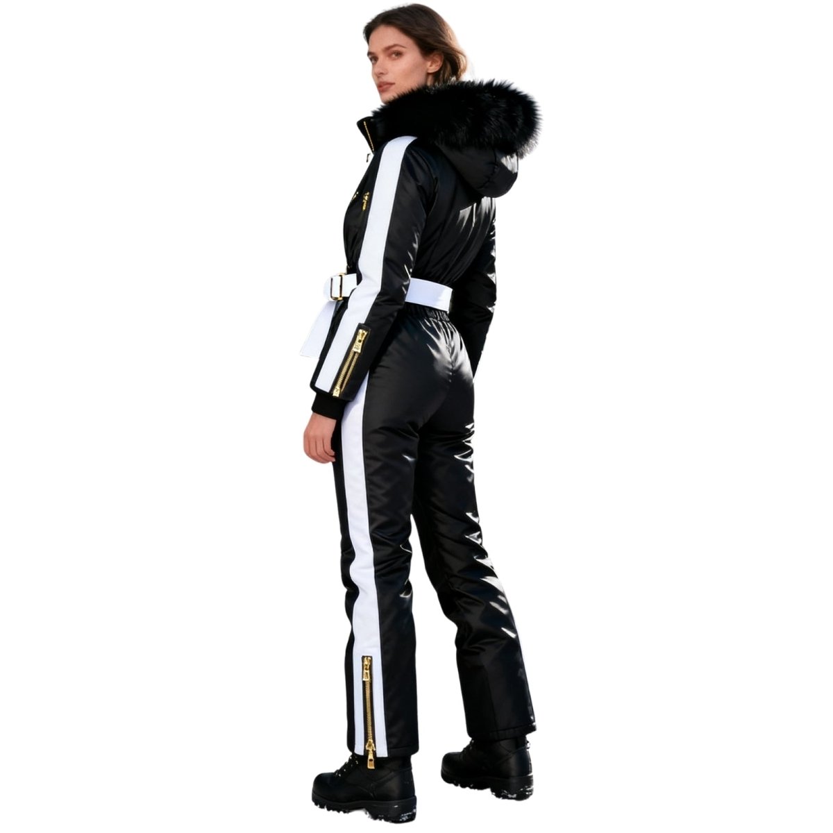 Woman wearing a black and white Kouvr ski suit with fur-lined hood on a white background