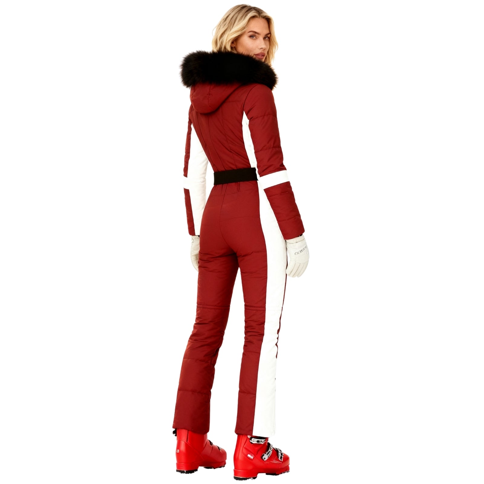 Person wearing a red Kouvr ski suit with white accents on a white background