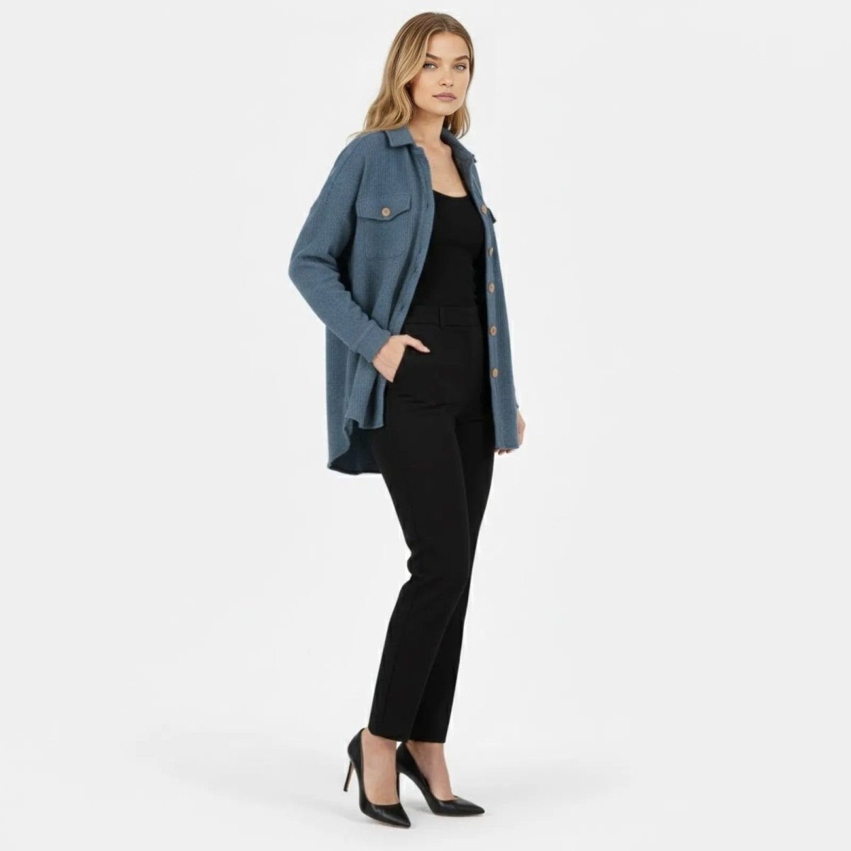 Side view of the Kouvr slate blue shacket showing its relaxed fit and high-low shirttail hem.