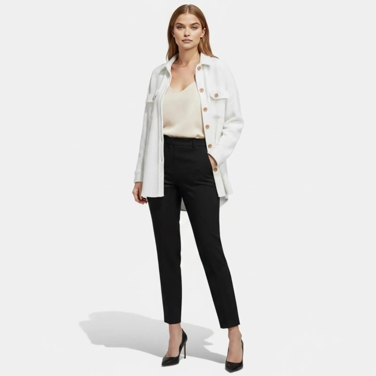 Model wearing the Kouvr Donna textured longline shacket in white, styled open with a cream camisole, black trousers, and black heels.