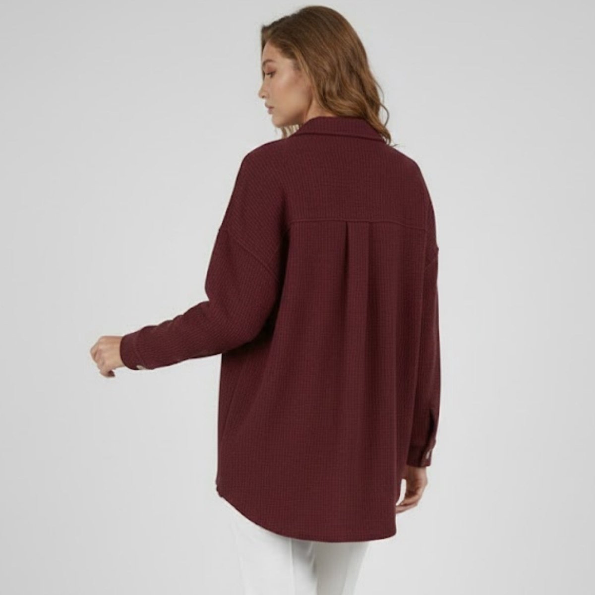 Back view of the burgundy Donna waffle knit shacket, showcasing the inverted back pleat and oversized drape.