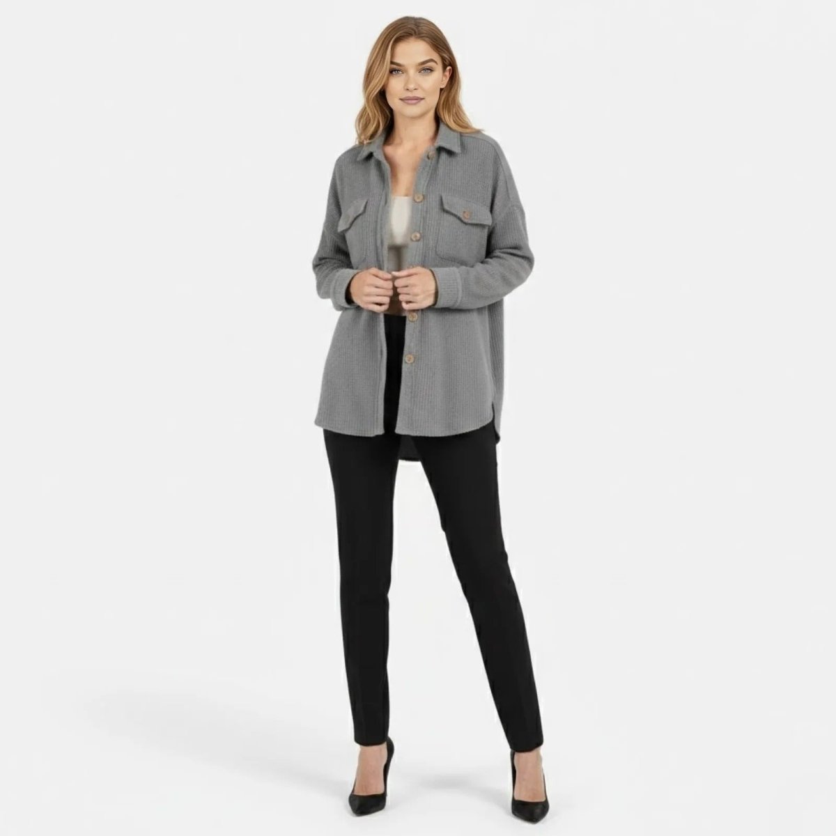 Model wearing the Kouvr Donna Waffle Knit Shacket in heather grey, styled open over a white camisole and black pants, front view.