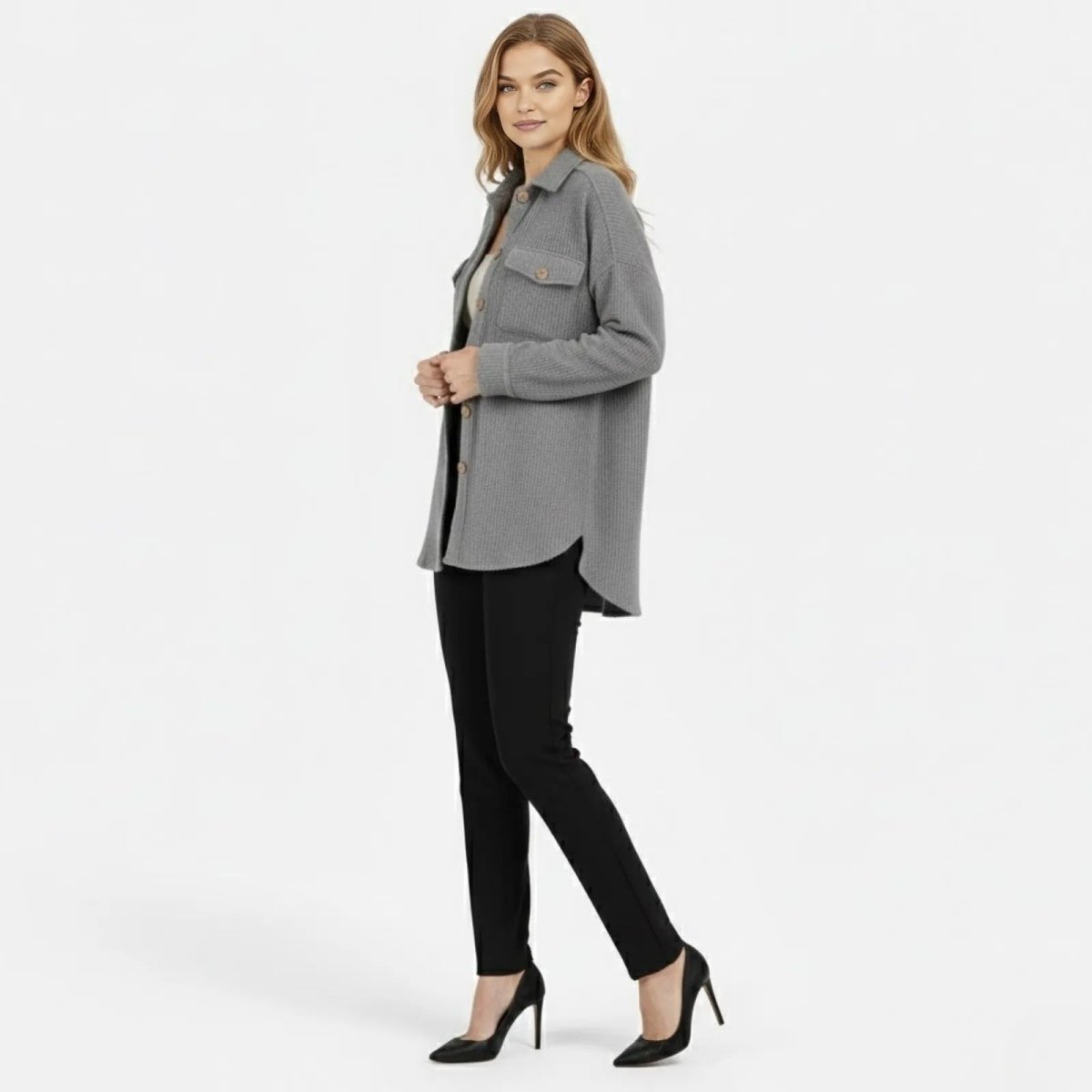 Side profile of a model in the heather grey Kouvr Donna Shacket showing the oversized fit and curved high-low hem.