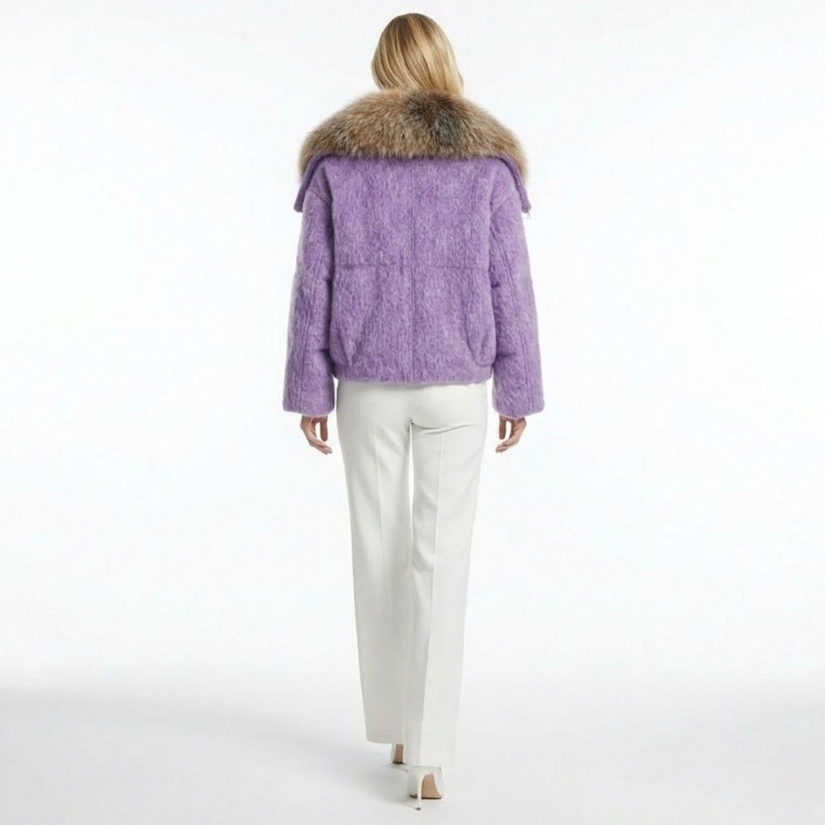 Back view of a model wearing the Kouvr Dorothy purple wool jacket, highlighting the oversized fur collar and textured boucle fabric.