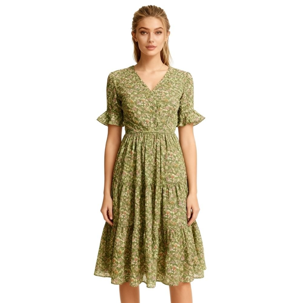 Woman wearing a green kouvr floral dress on a white background