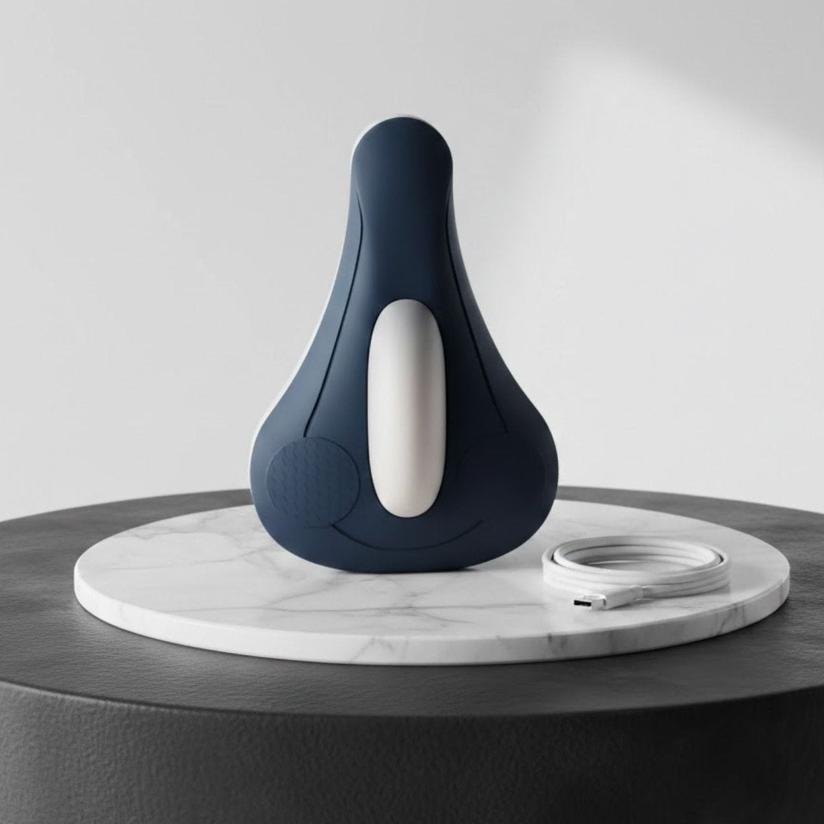 Kouvr Elite Pelvic Floor and PC Muscle Trainer in Navy Blue with USB-C charging cable.