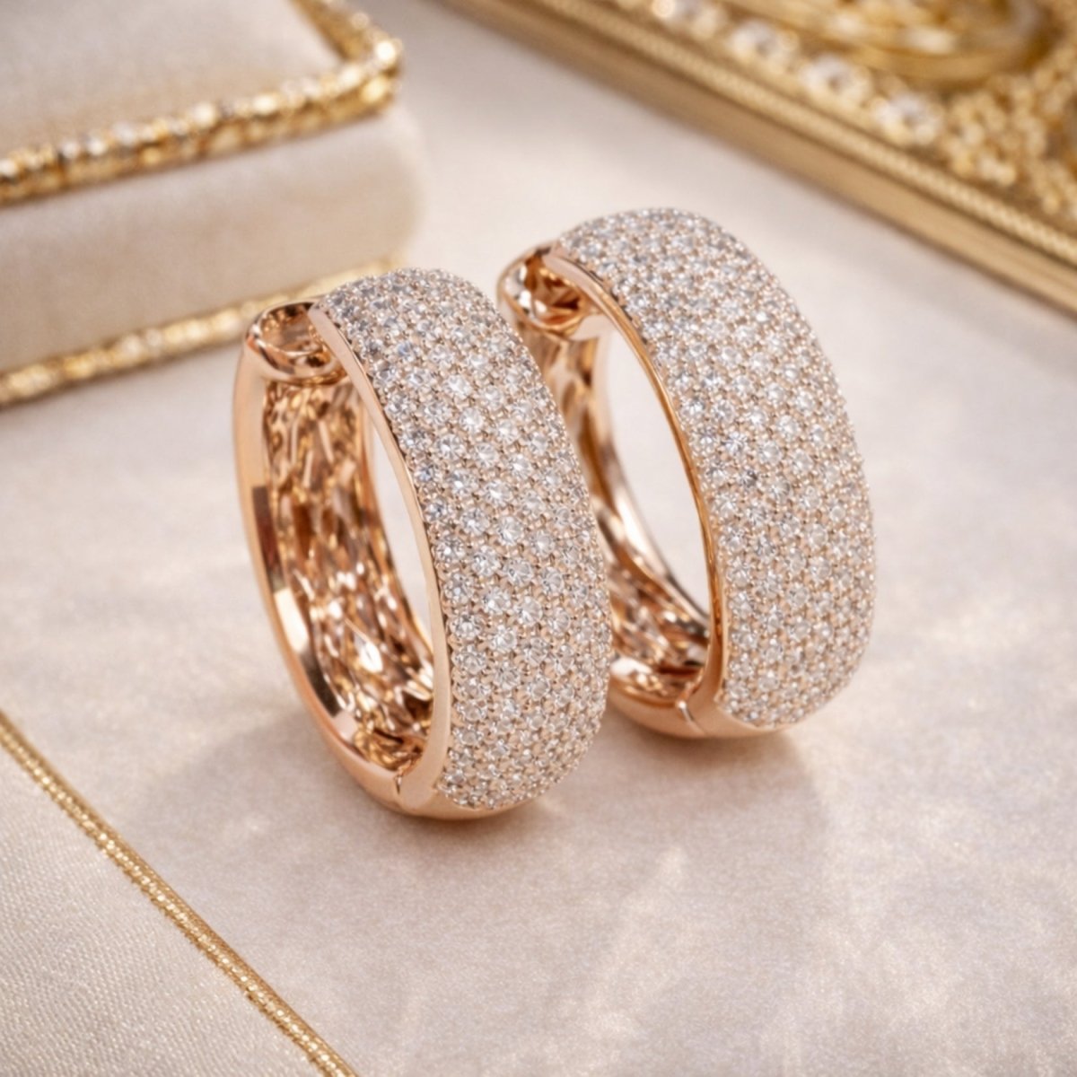 A detailed shot showing the intricate open-work inner gallery of the 18k rose gold Kouvr Emmiline diamond hoop earrings.