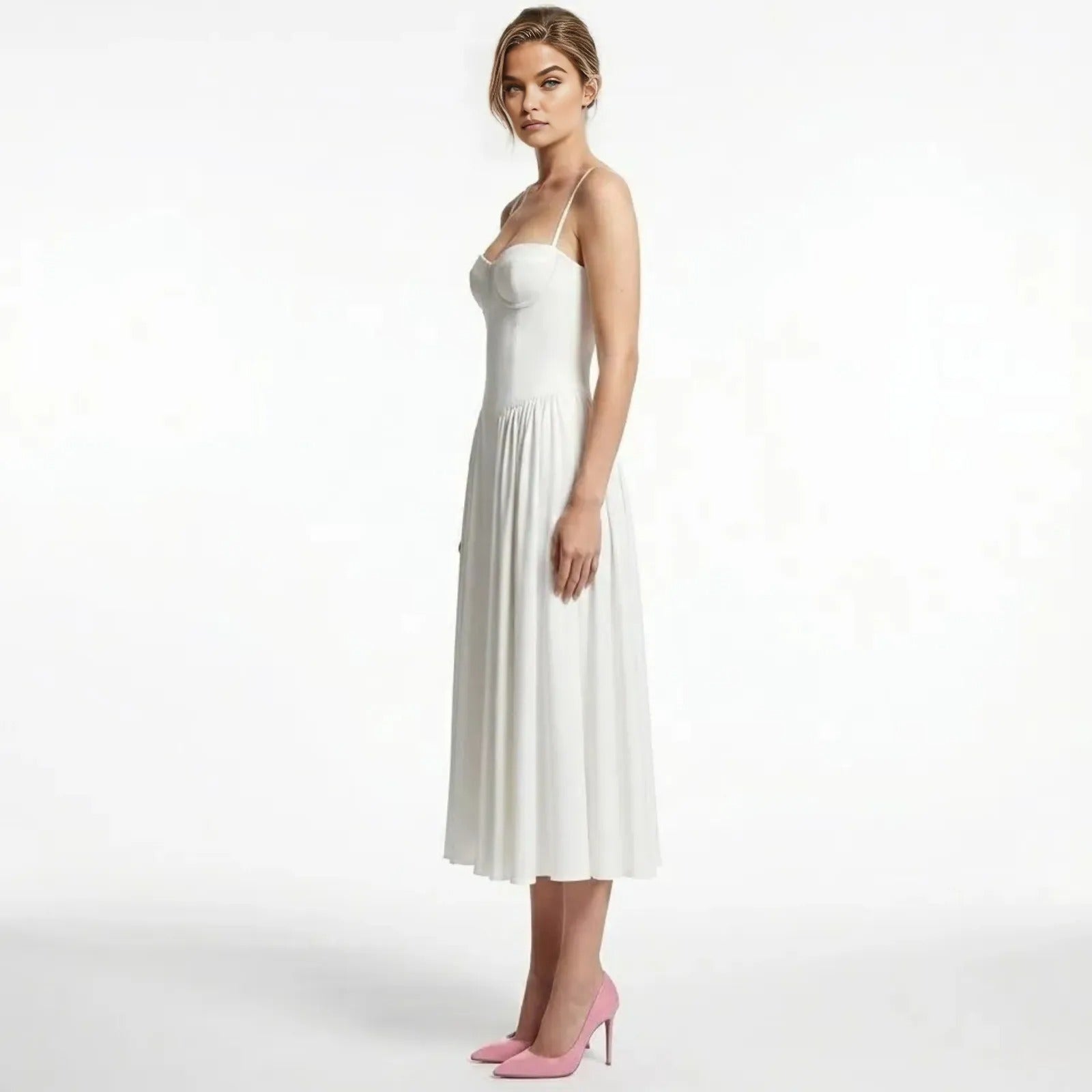 Side profile of a model in the Kouvr Fashion Evdokia white midi dress showing the structured bodice and pleated A-line skirt.
