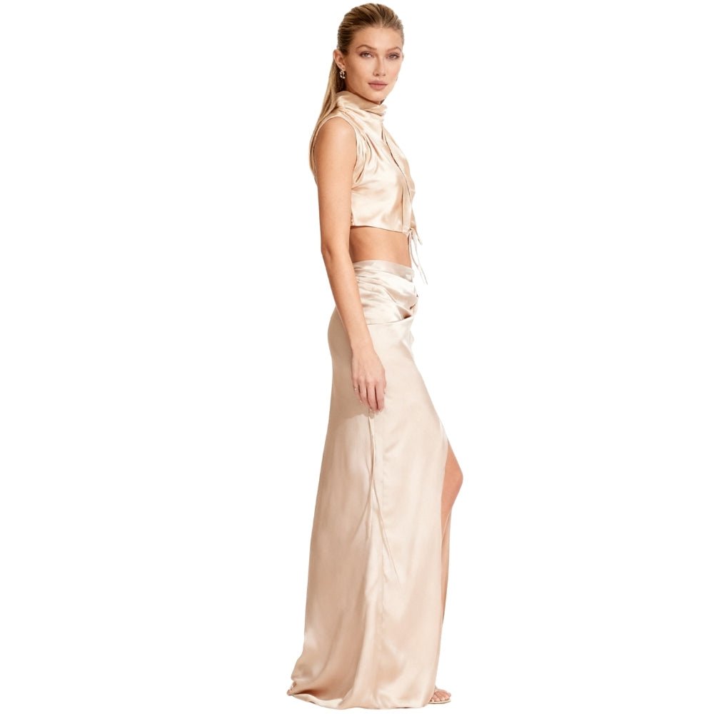 Woman wearing a Cream Kouvr satin two-piece outfit on a white background