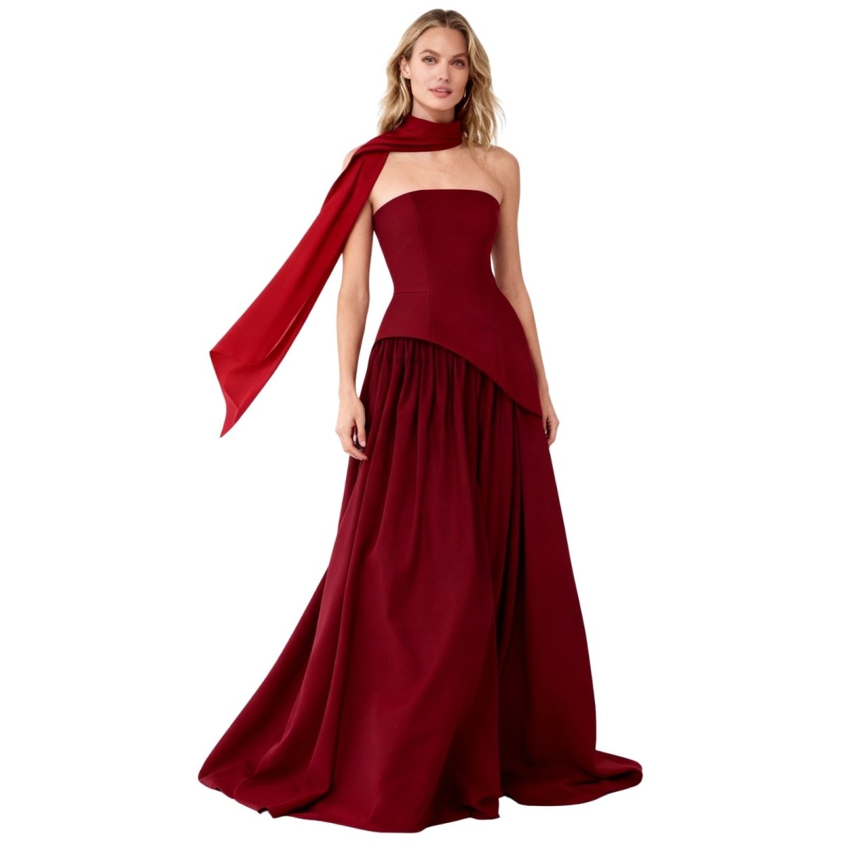Woman wearing a burgundy Kouvr strapless gown with a long train on a white background