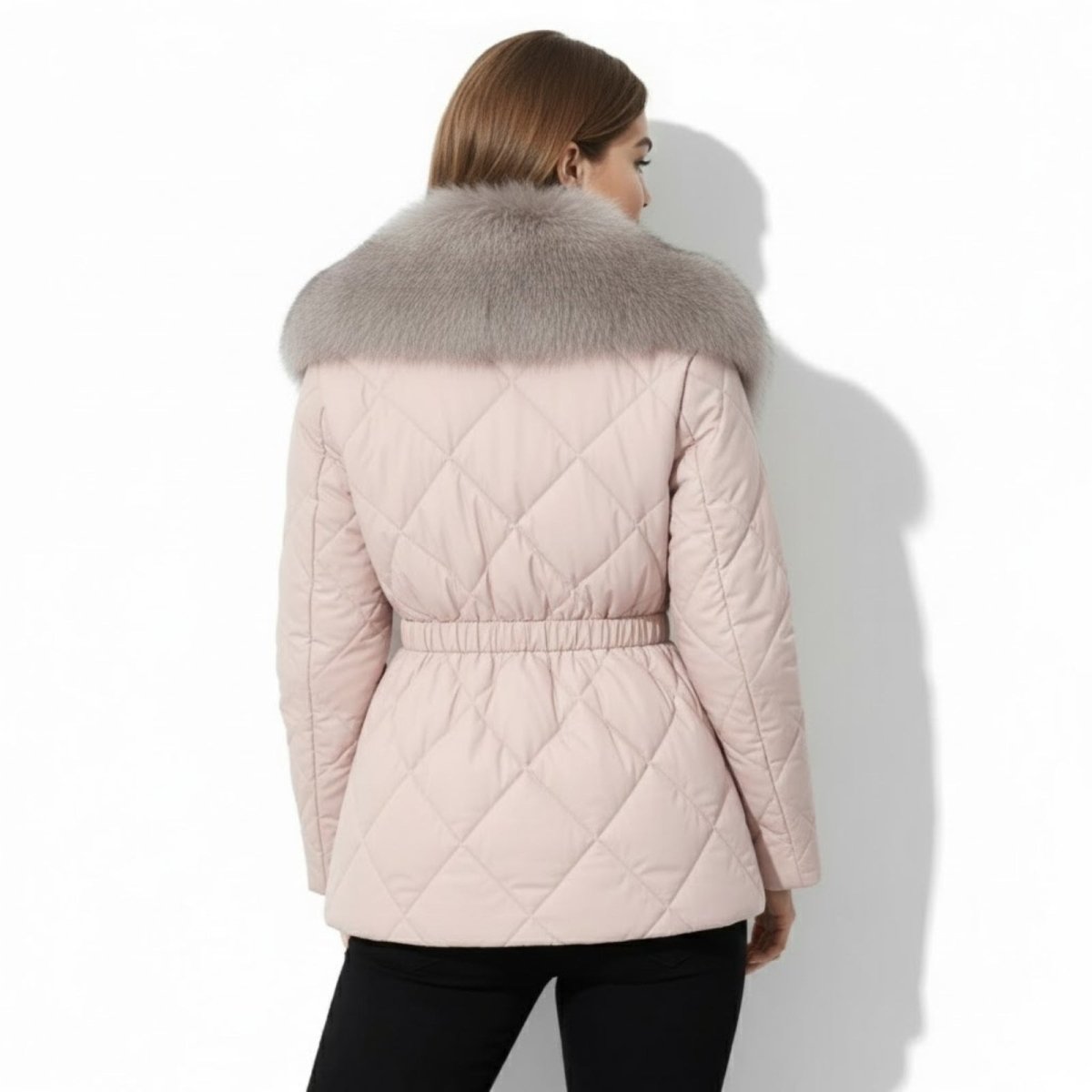 Back view of a model wearing a apricot diamond-quilted jacket, showcasing the elasticated waistband and full fur collar.