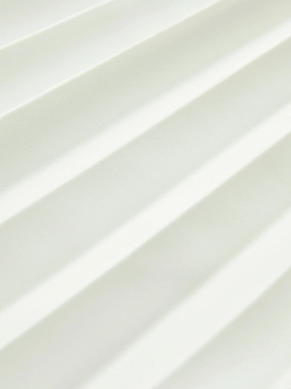 architectural," "sculptural," "asymmetrical," "bonded crepe," and "sunray pleats