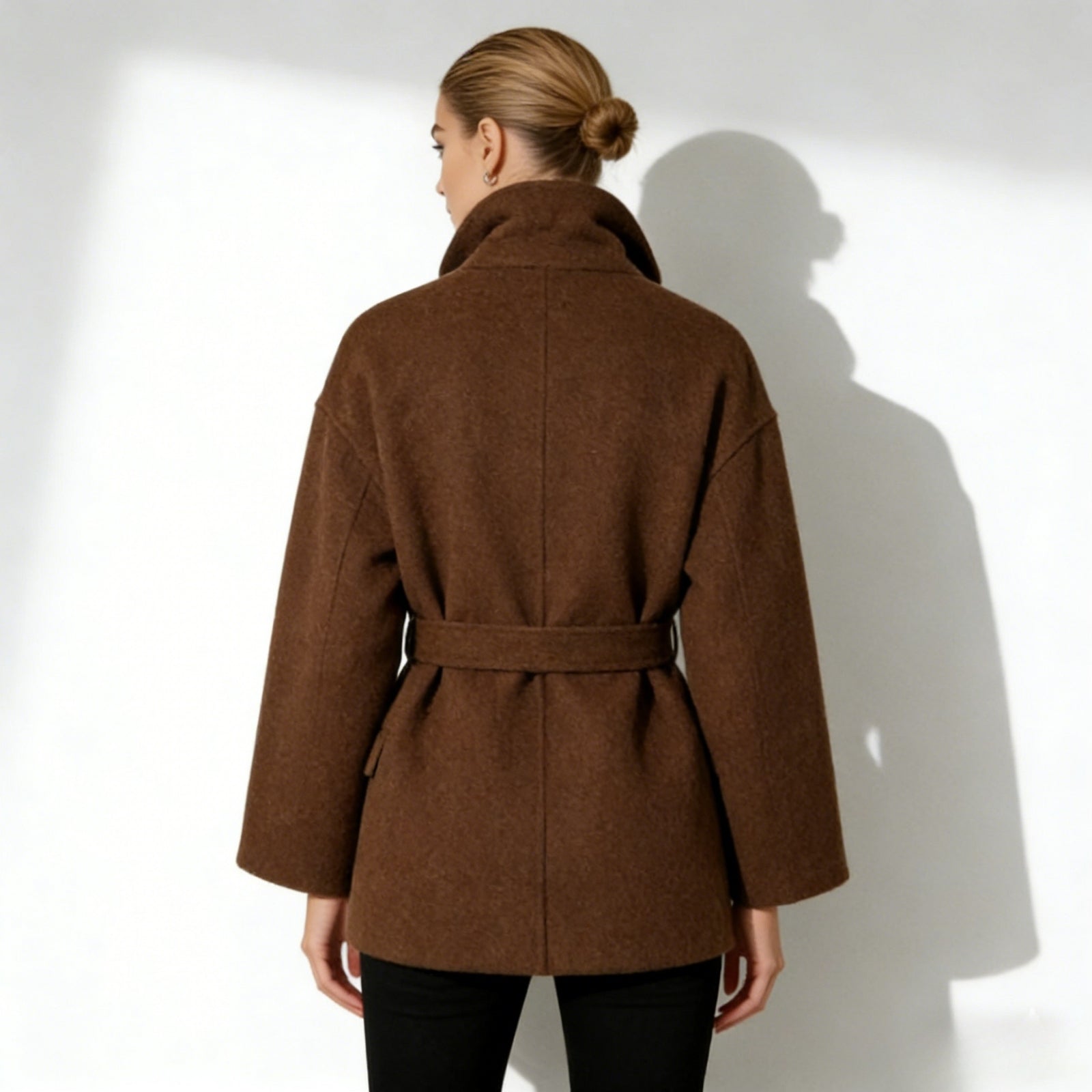 Back view of the Kouvr Fashion short brown wool coat, highlighting the belt and minimalist construction.