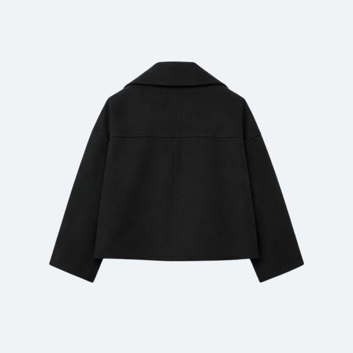 Product-only photo of the back of the black cropped jacket, highlighting the yoke and clean construction.