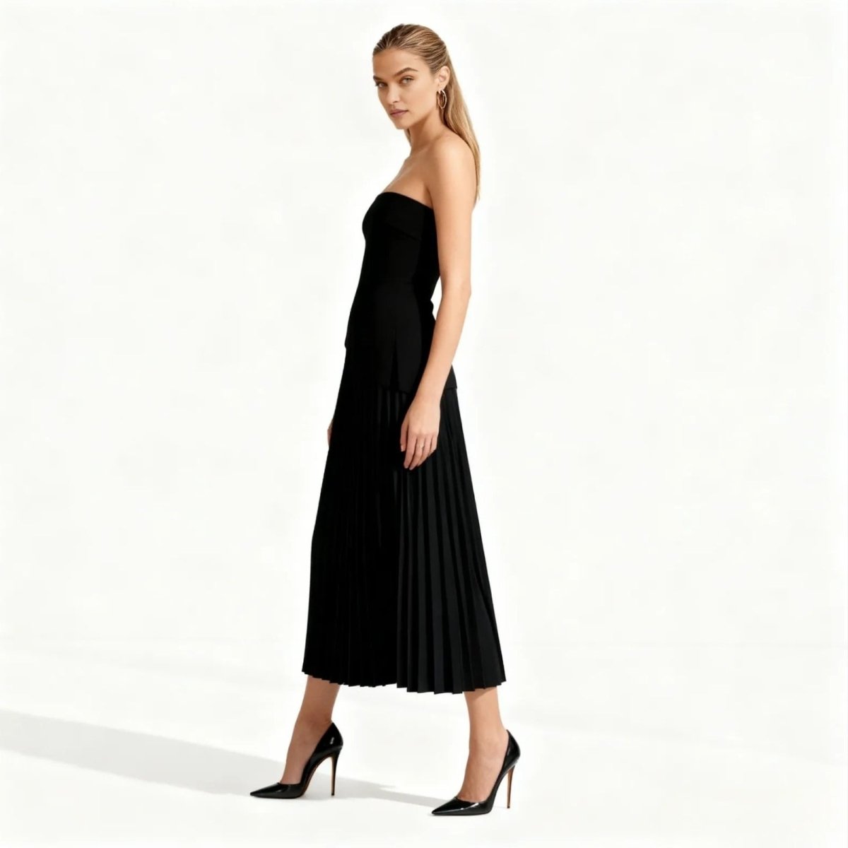 Woman wearing a black strapless dress on a white background