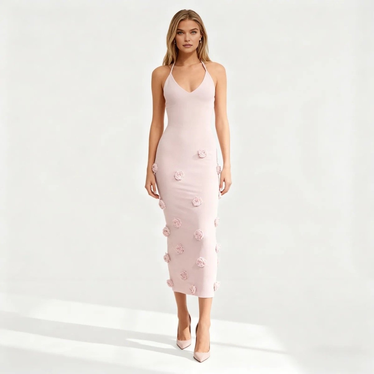 Pink kouvr dress with floral embellishments on a white background