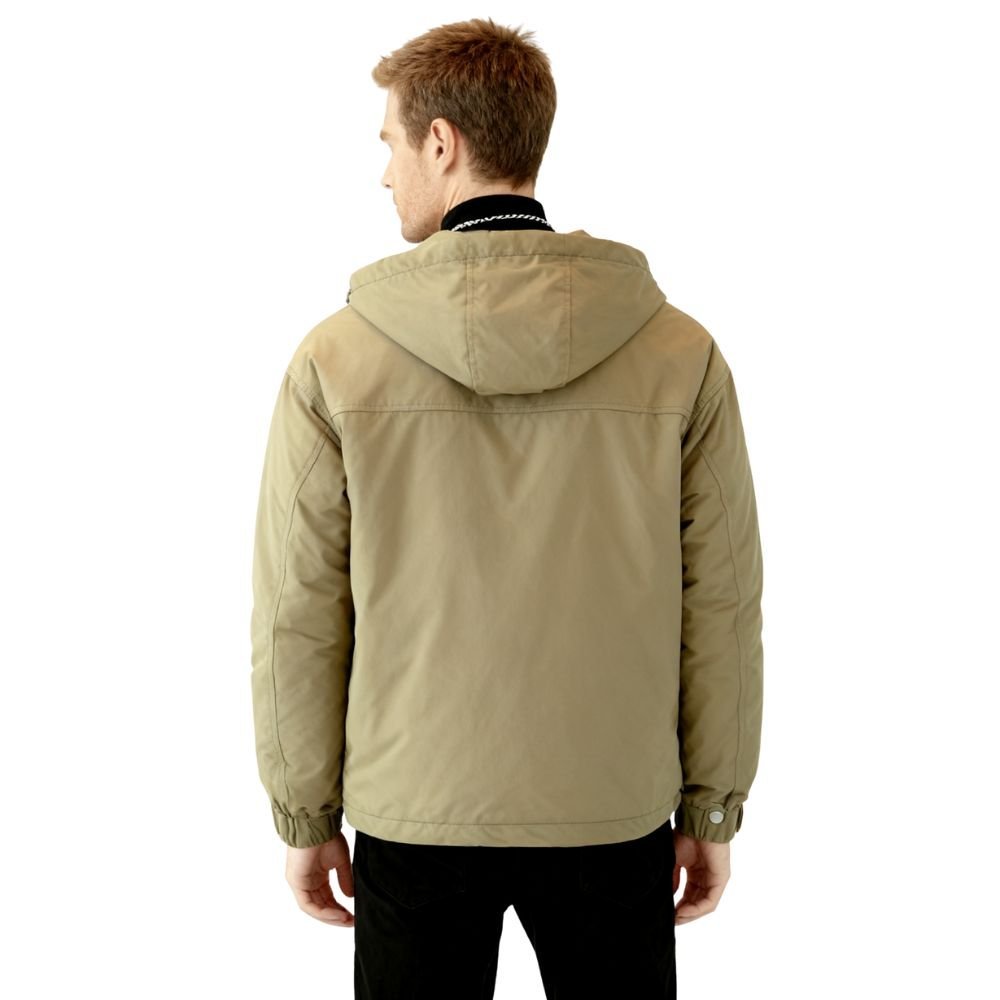 Person wearing a green kouvr hooded jacket on a white background